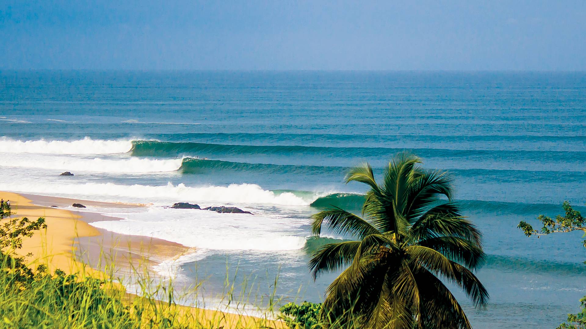 Kendeja Beach Liberia with Atlantic Ocean waves and palm trees