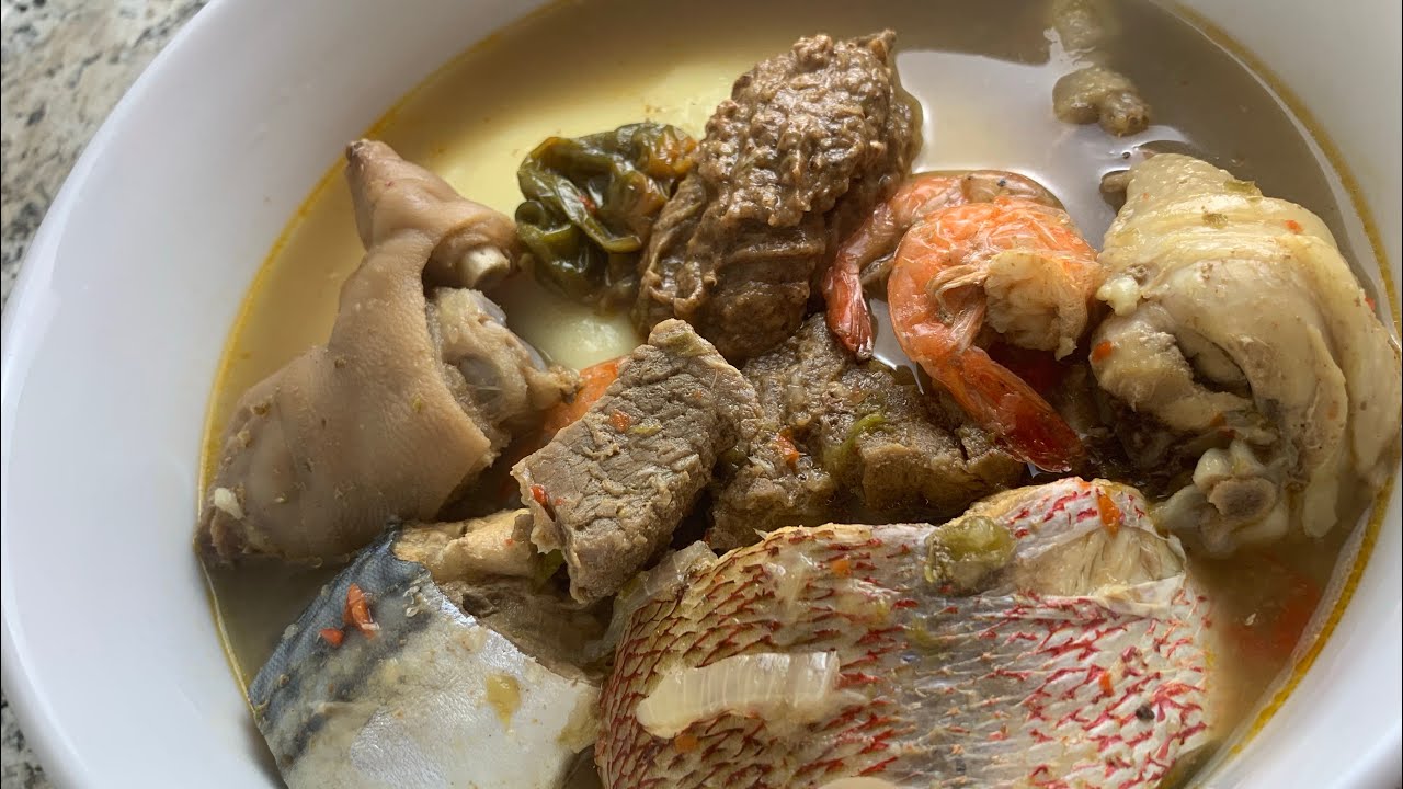 Traditional Liberian food spread with pepper soup fufu and palava sauce