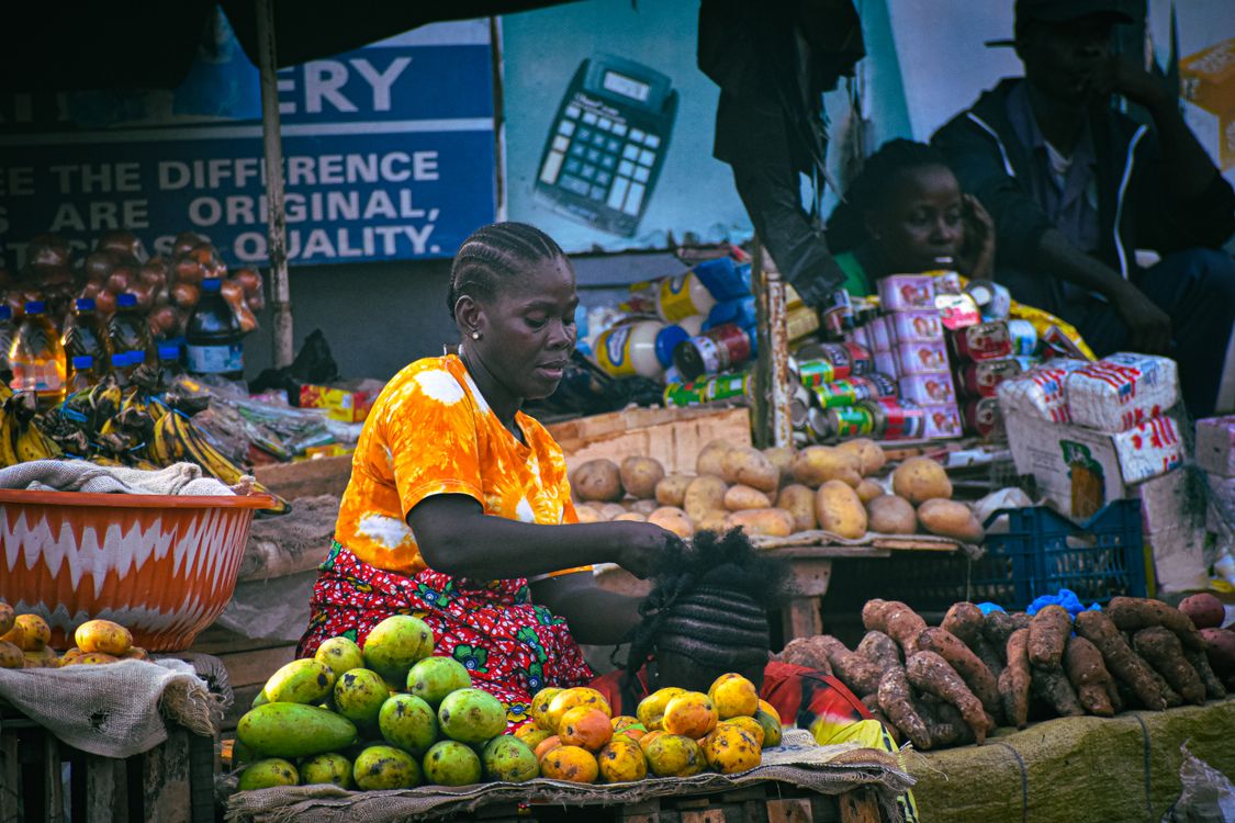 Liberian market vendors selling goods with energy and smiles