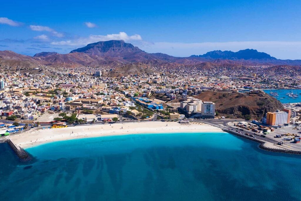 Aerial view of a pristine Liberian beach with turquoise Atlantic Ocean waves and lush green coastline
