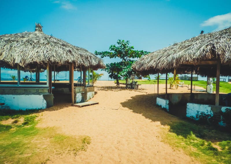 Traditional Liberian cultural village near the beach with ocean backdrop