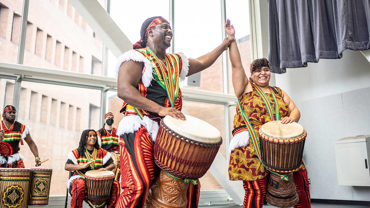 Liberian musicians playing traditional drums at a cultural festival