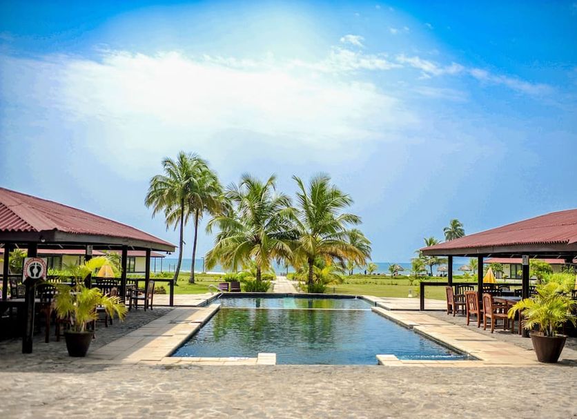 Kendeja Resort and Villas beachfront pool and palm trees in Monrovia Liberia