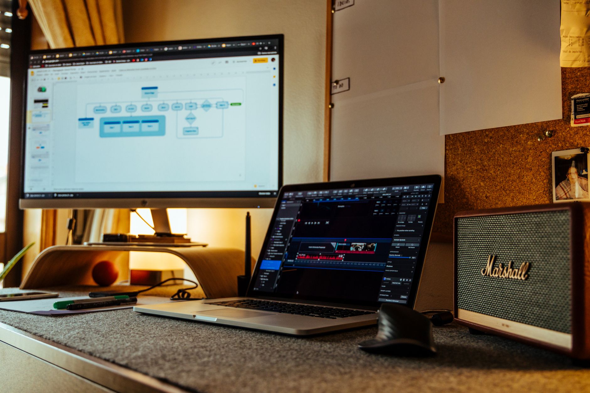 Creator sitting at a desk building a content workflow on a laptop with analytics charts visible