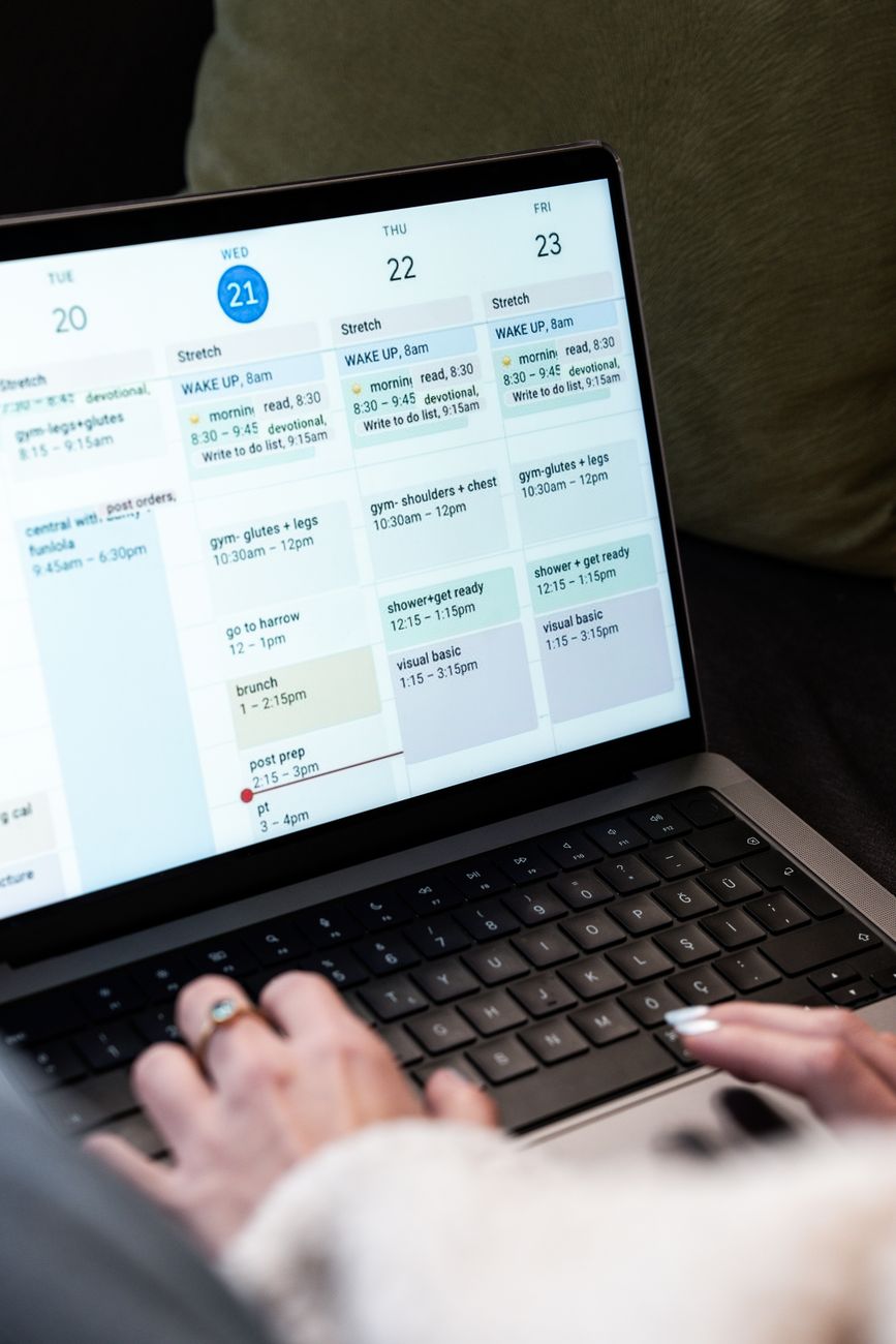 Creator planning social media content on a laptop with scheduling dashboard open