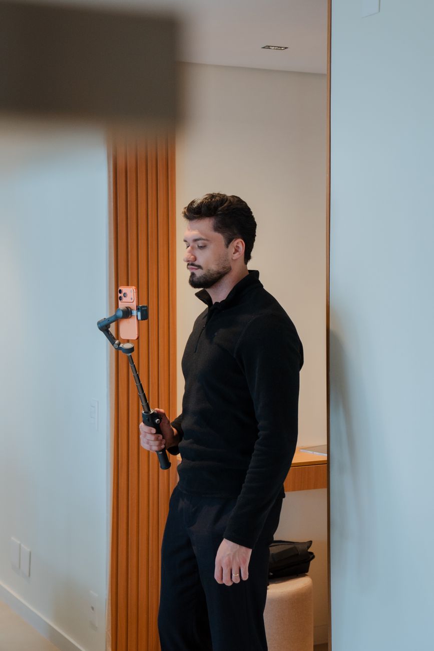 Creator filming a YouTube Shorts video on a smartphone with ring light