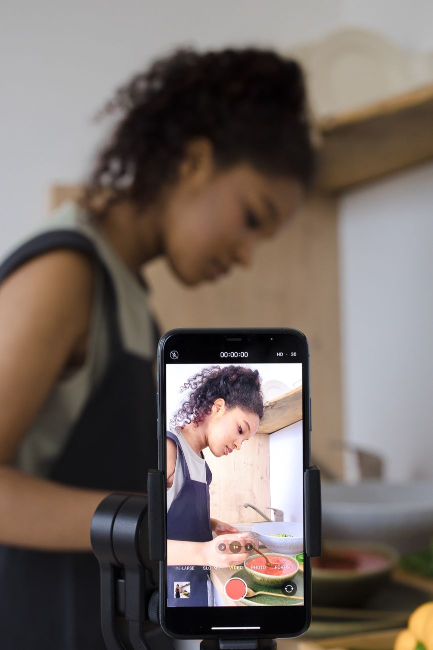 Creator writing Instagram Reels caption on smartphone with AI tool open