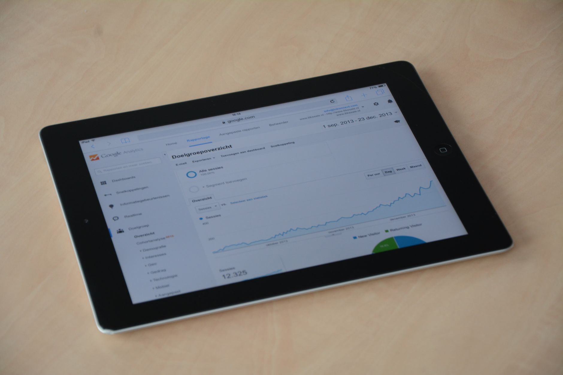 Person reviewing social media analytics dashboard on tablet showing engagement metrics