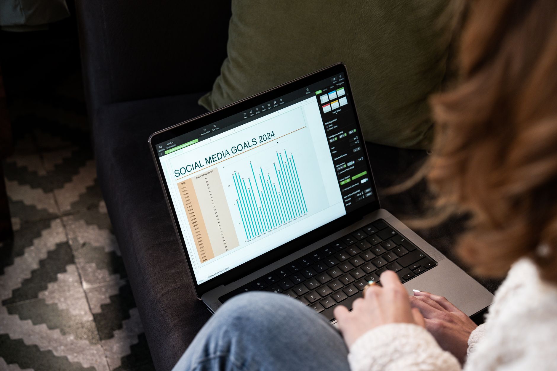 Solo creator working on laptop with social media dashboard open