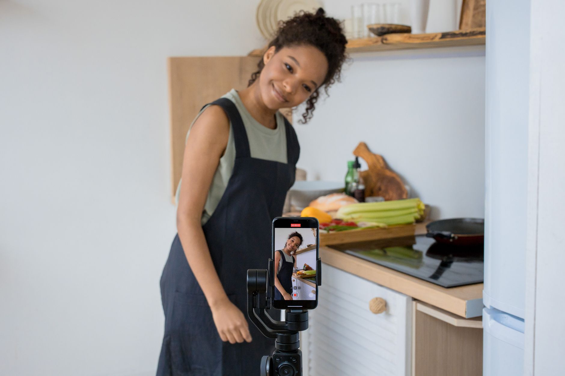 Person filming short-form video content on smartphone with ring light