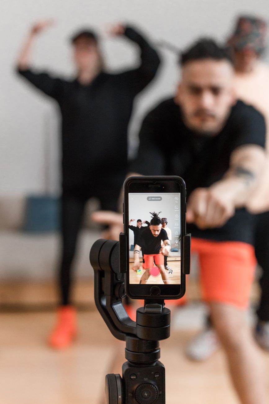 Creator filming a TikTok short video with a ring light and smartphone setup