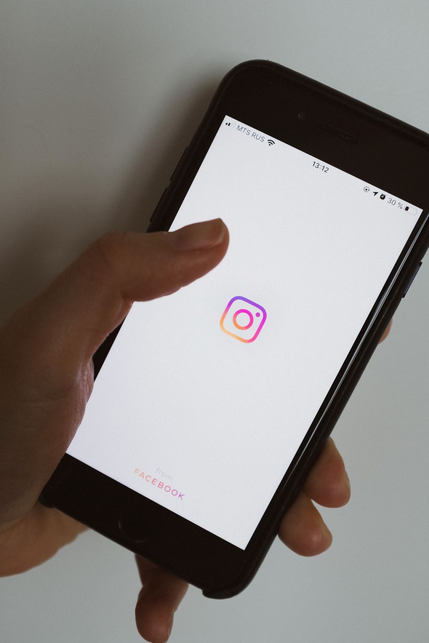 Instagram caption being generated by AI tool on a smartphone screen