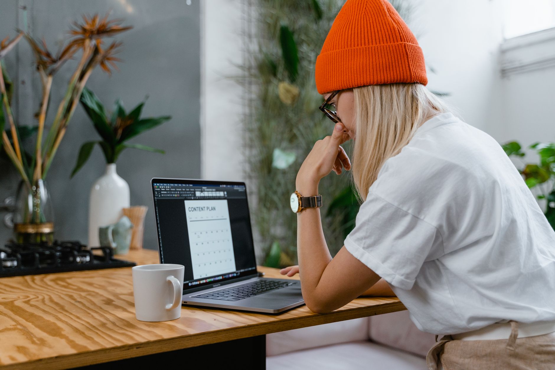 Content creator planning TikTok videos on a laptop with analytics charts
