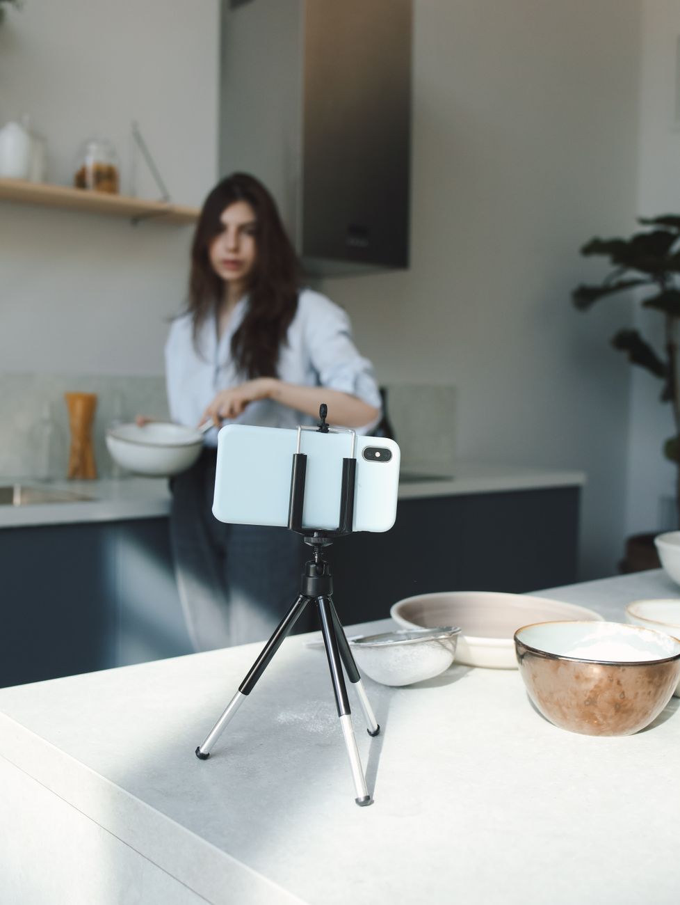 Creator filming a YouTube Shorts video on a smartphone with ring light