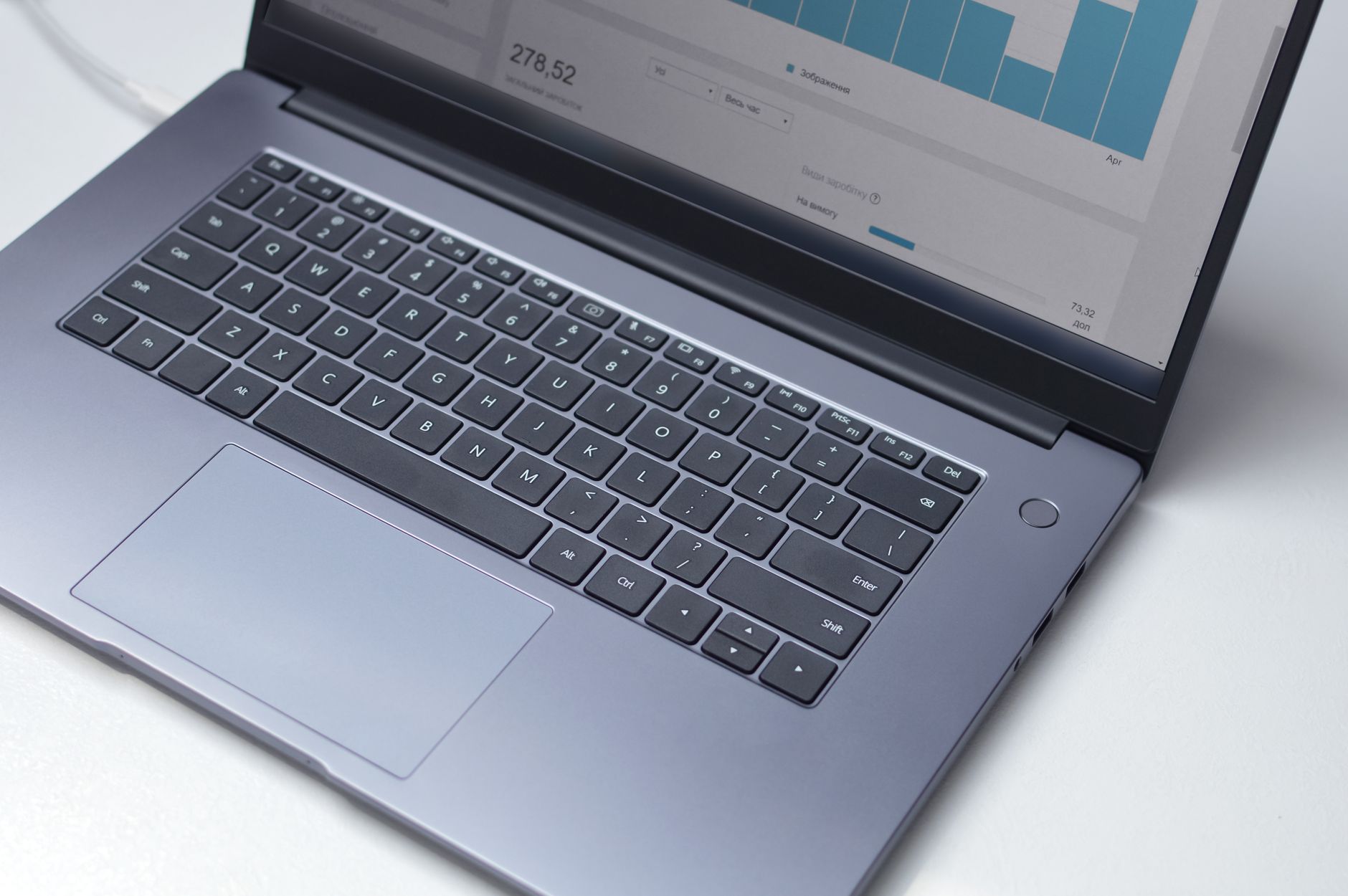 YouTube Shorts title formulas displayed on a laptop screen with analytics dashboard