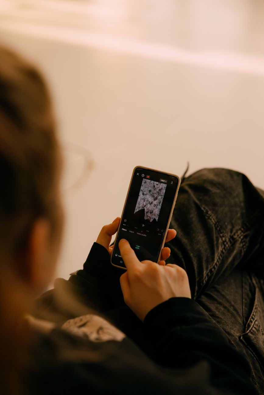 Person using smartphone to create Instagram captions with AI tool
