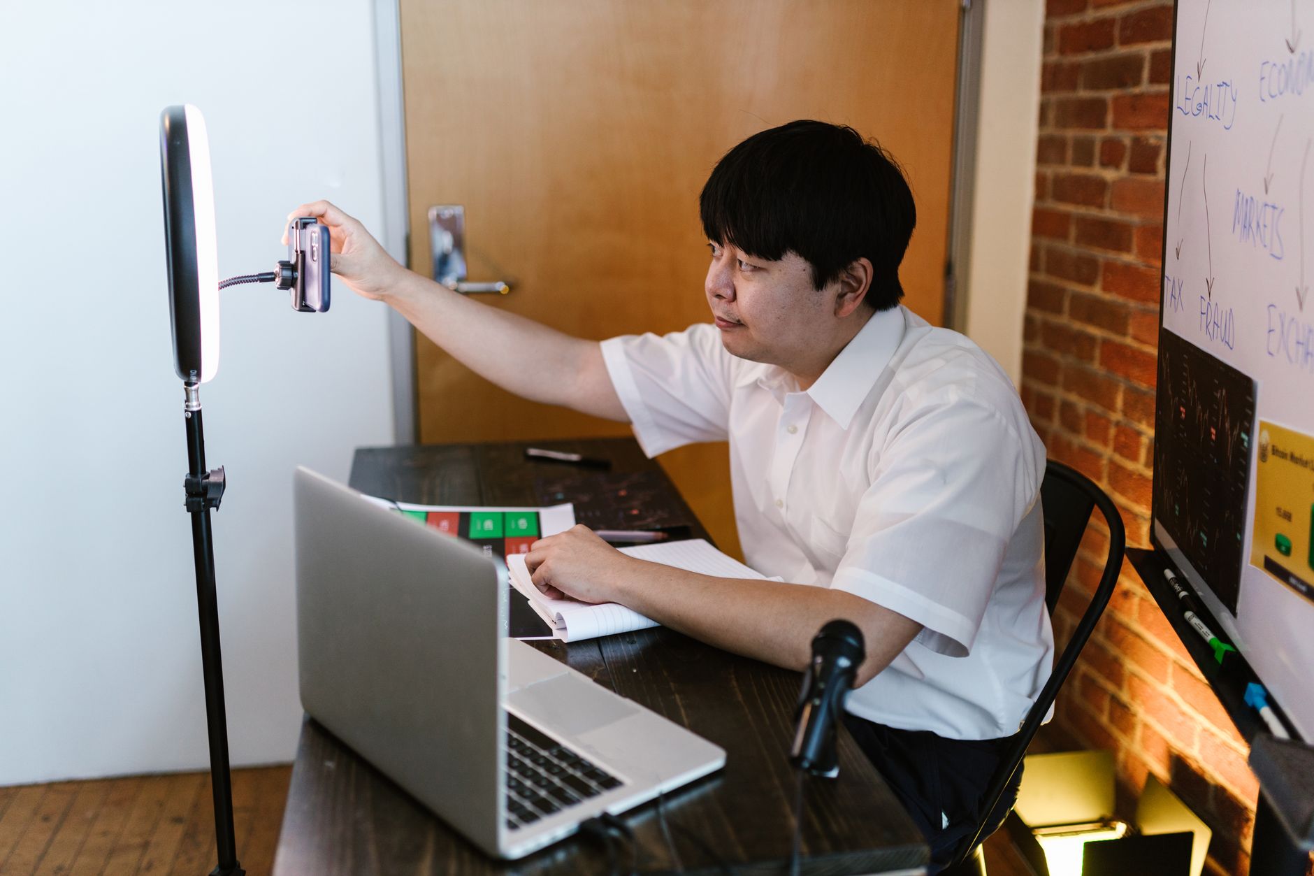 Creator analyzing TikTok video scripts on laptop and phone