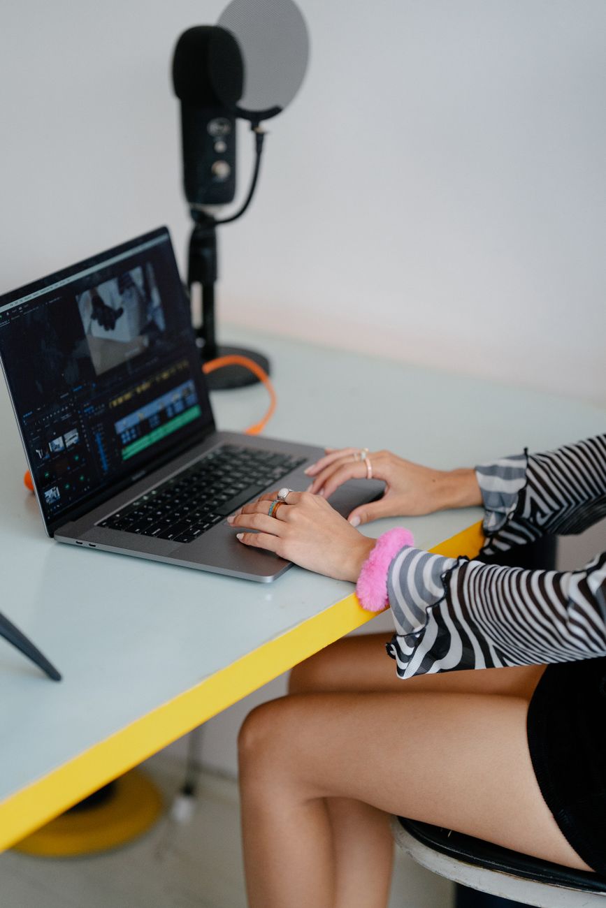 Creator building a TikTok script workflow on a laptop with AI tools open