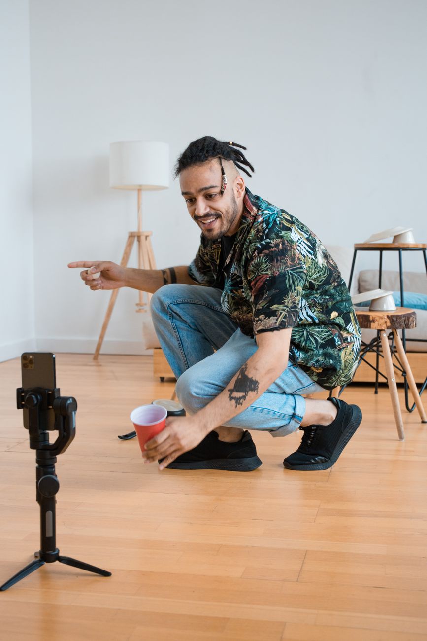 Creator filming a TikTok short-form video with a ring light and smartphone