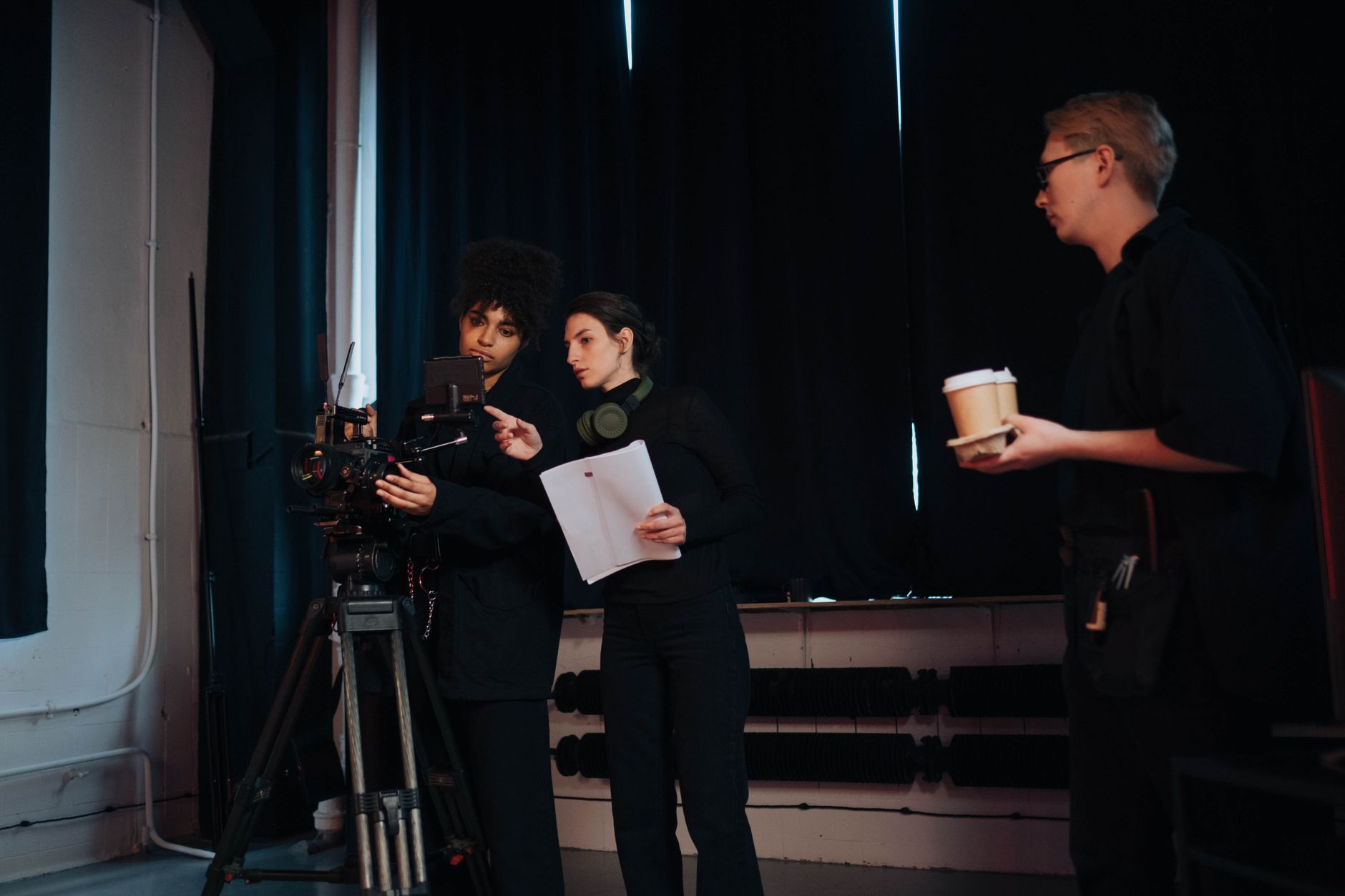 TikTok script on paper next to a smartphone filming setup