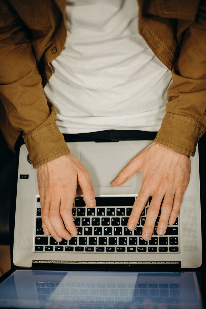 Content creator using AI writing tool on laptop at a desk