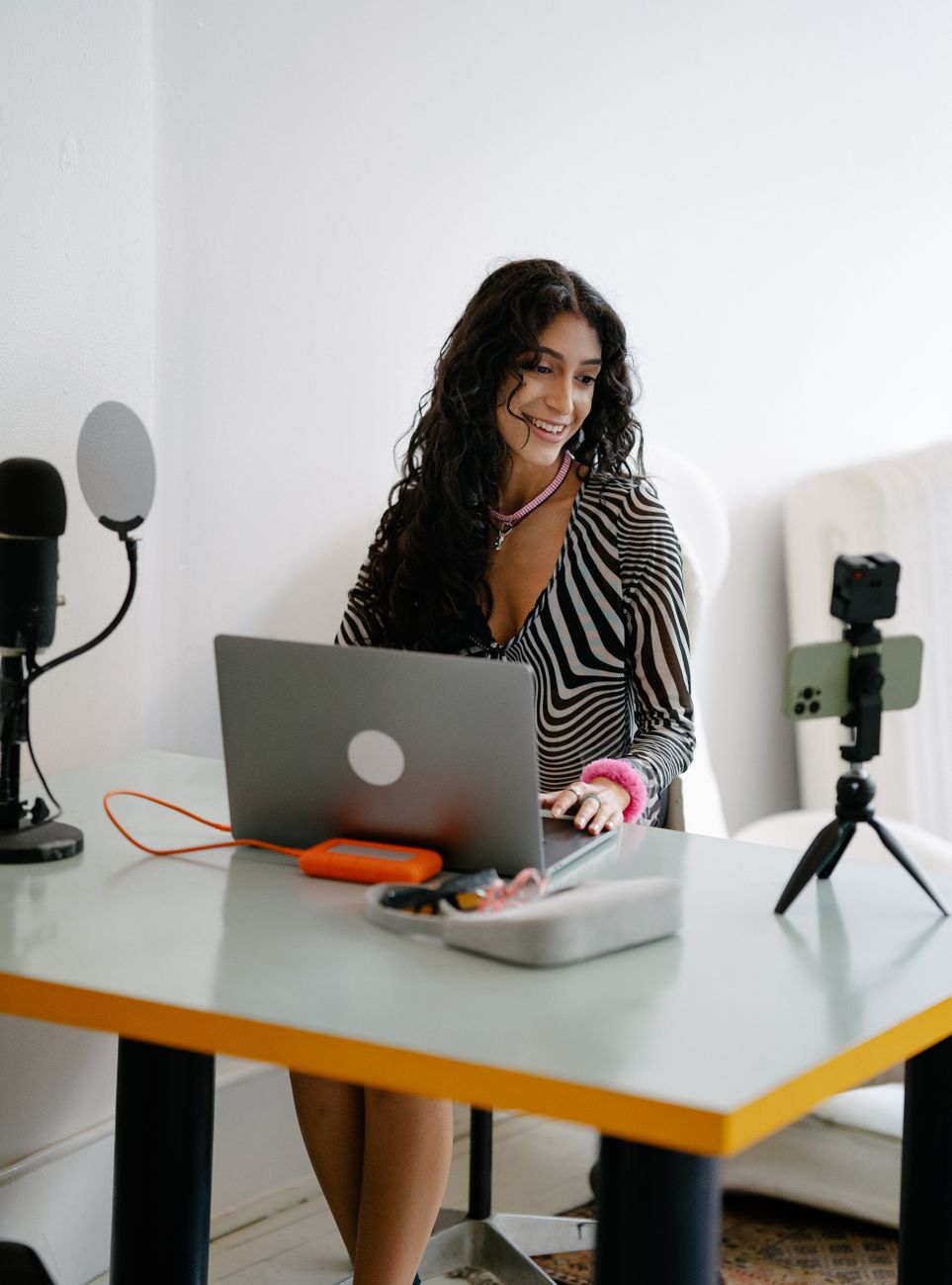 Creator using AI tools on laptop to generate social media content