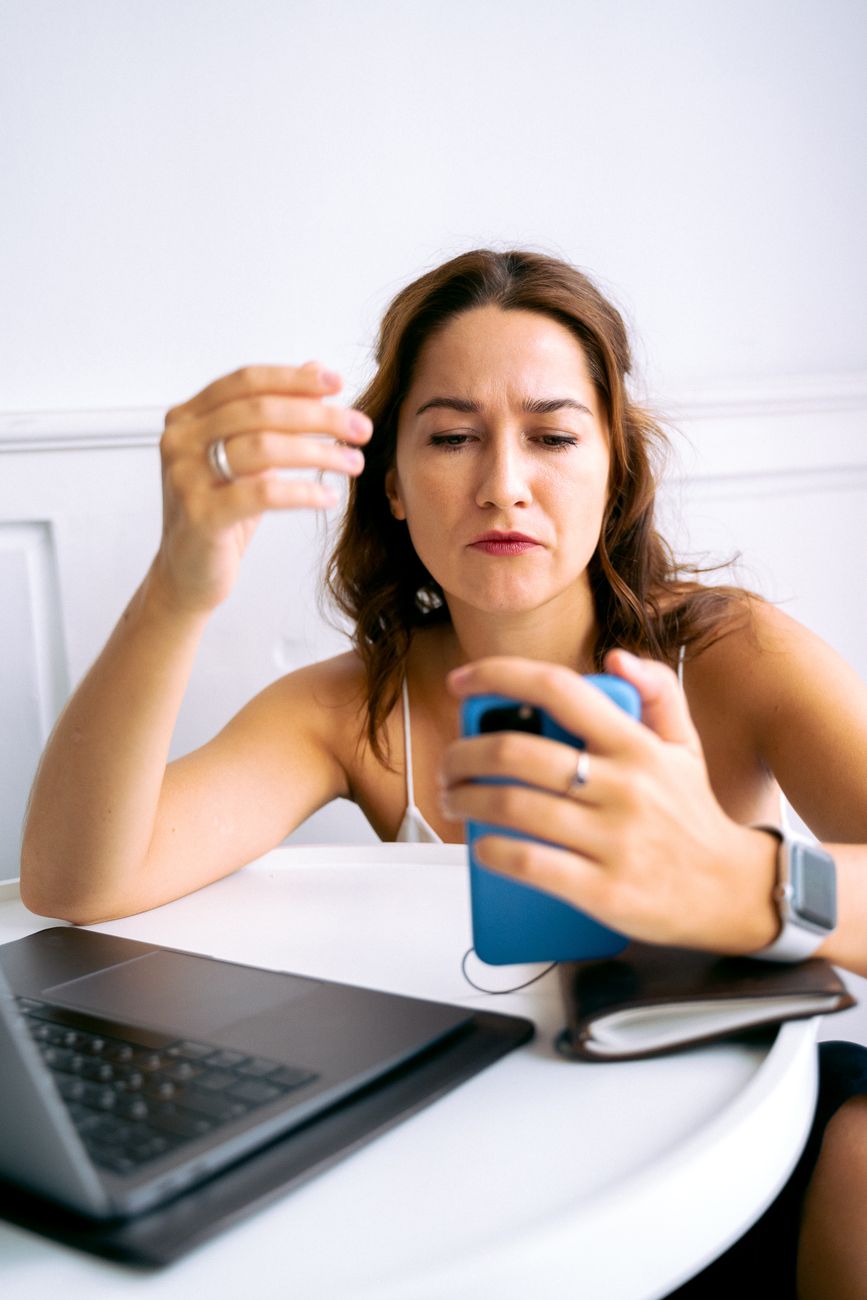 Frustrated creator looking at a phone with missing TikTok Creator Tools menu