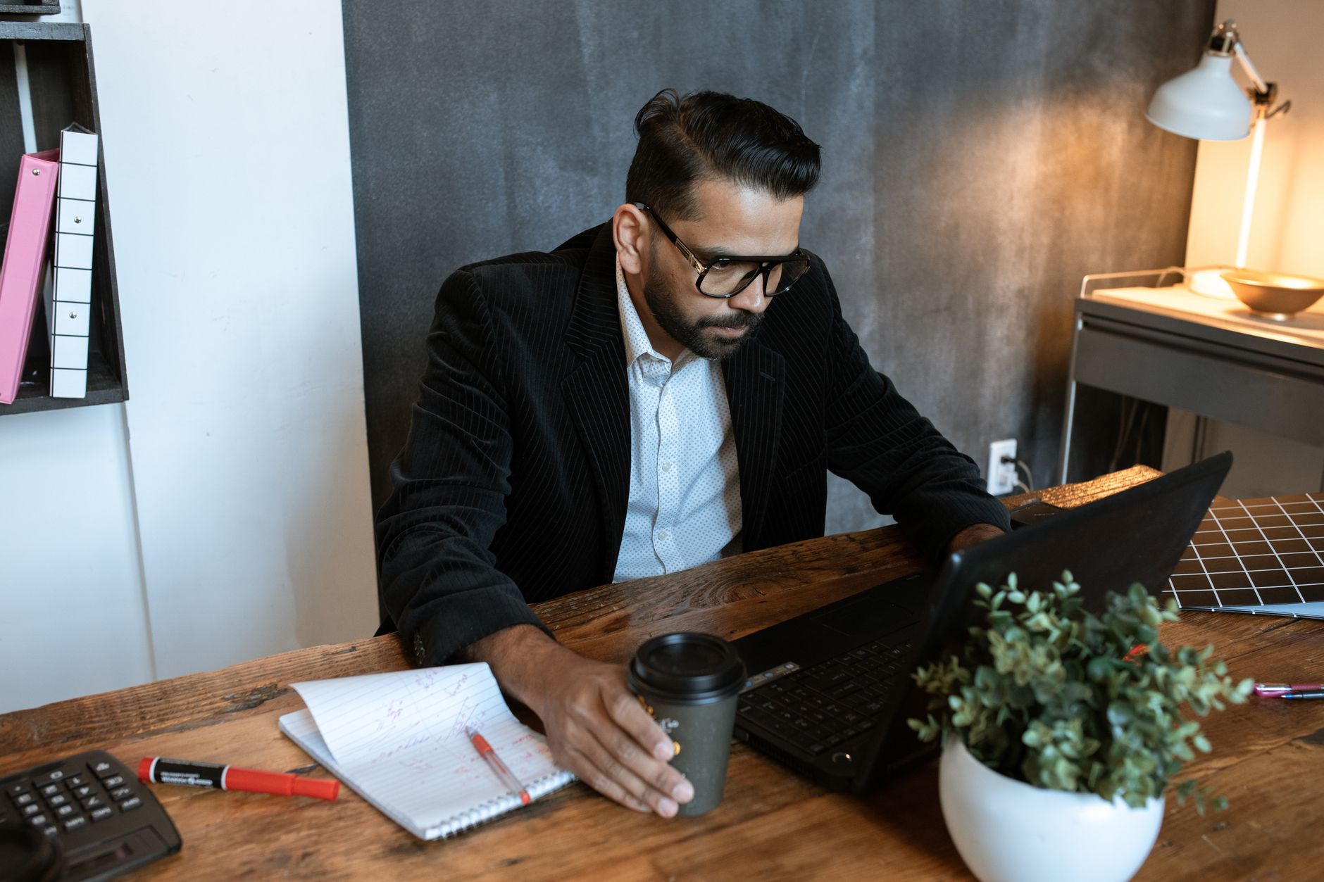 Small business owner reviewing digital marketing strategy on laptop