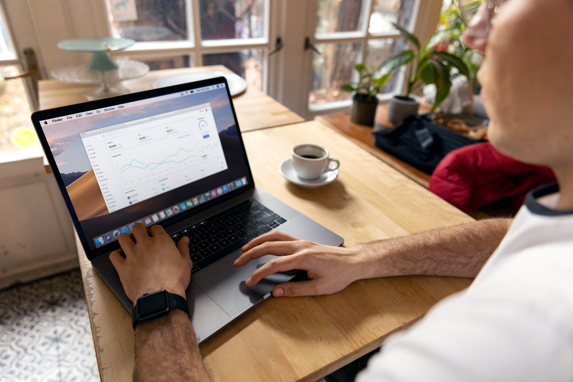 Remote digital marketer working on laptop with analytics dashboard open