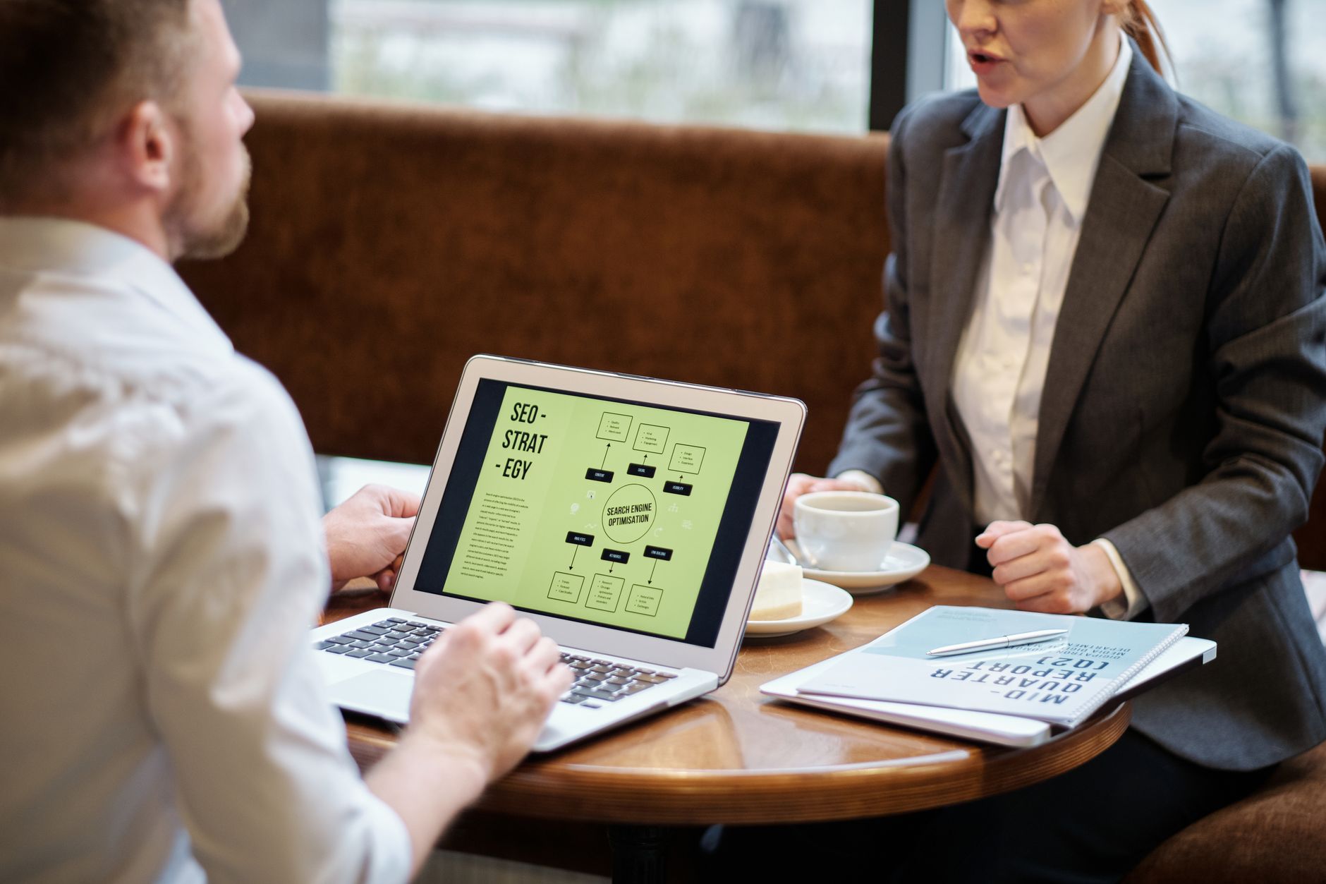 Digital marketer reviewing client strategy on laptop at a modern desk