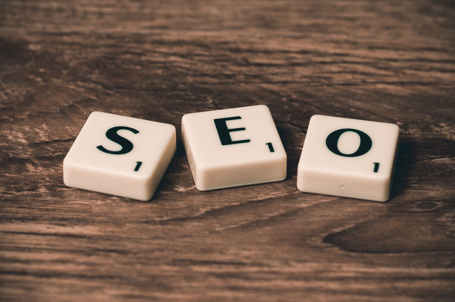 Writer creating SEO blog content on a laptop with analytics charts nearby