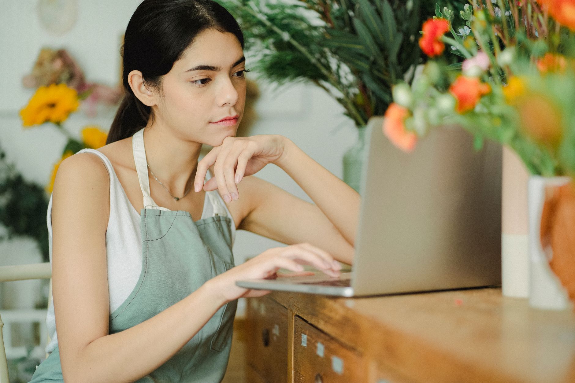 Small business owner reviewing digital marketing strategy on laptop
