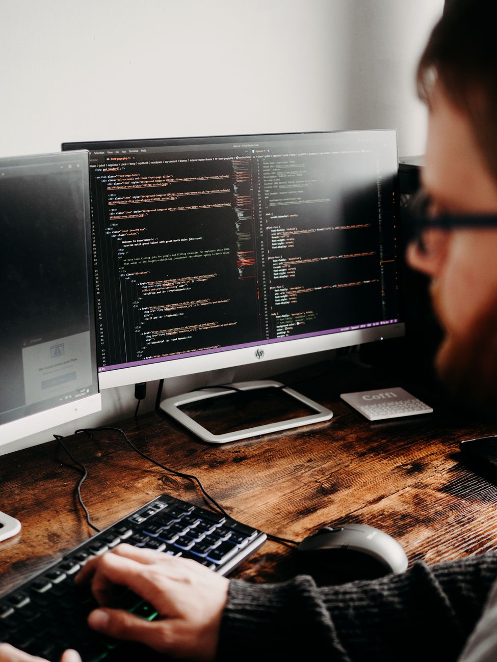 Web developer optimizing a website on a desktop computer
