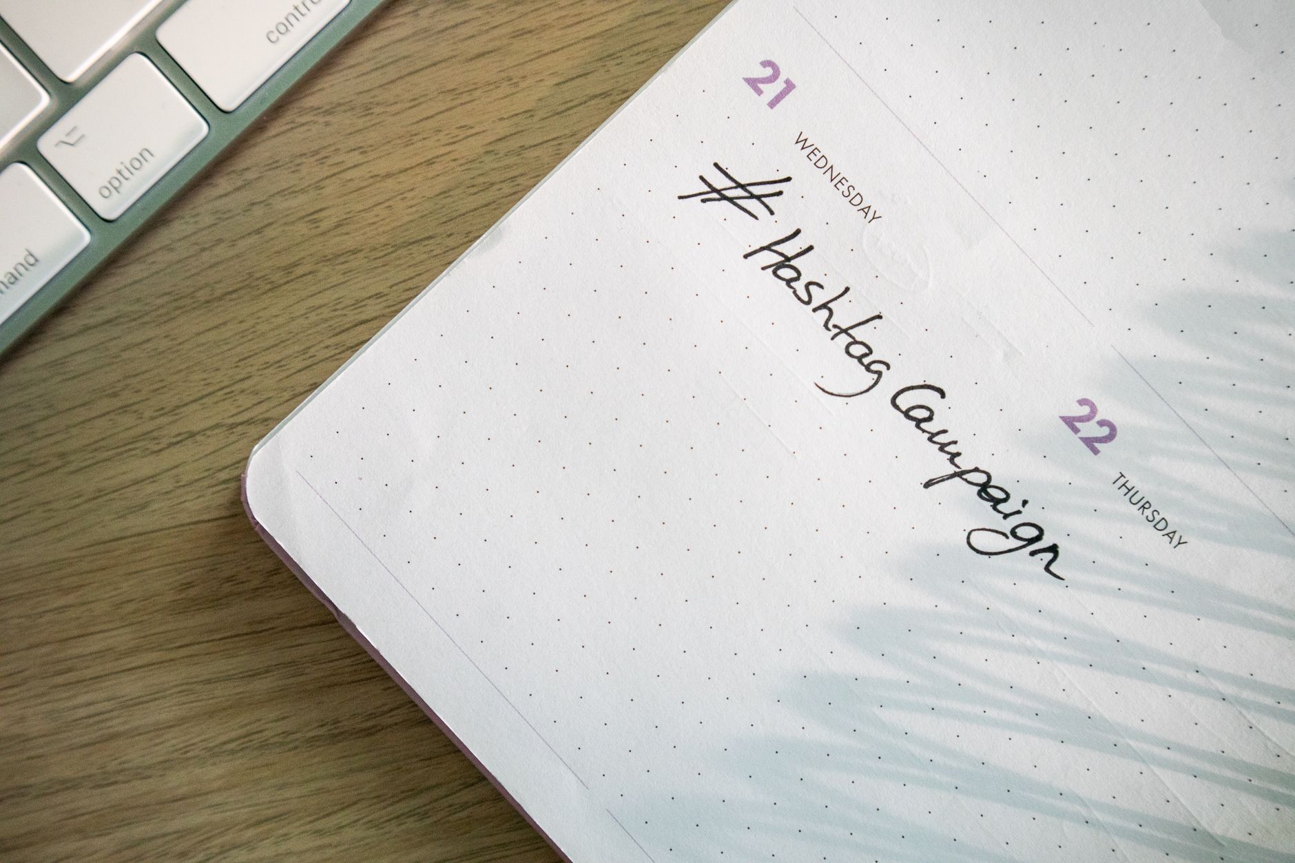 Social media content calendar on a desktop screen with engagement metrics