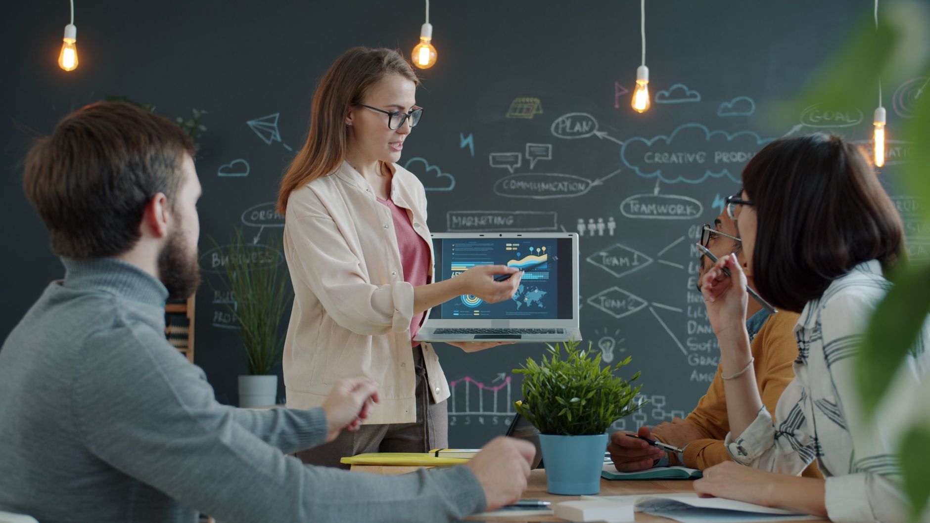 Marketing team collaborating on laptop reviewing content strategy