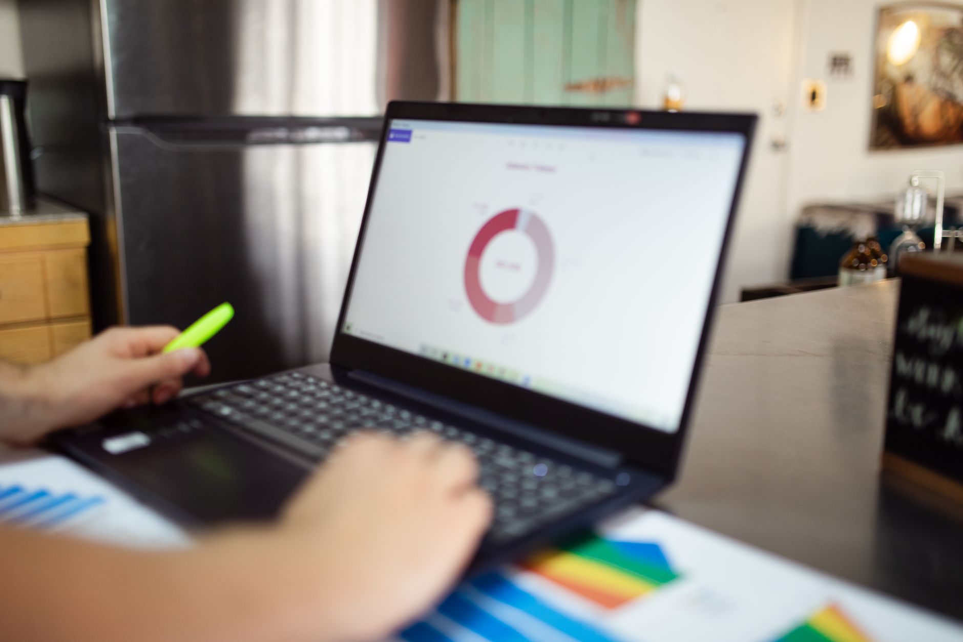 Small business owner reviewing digital marketing dashboard on laptop