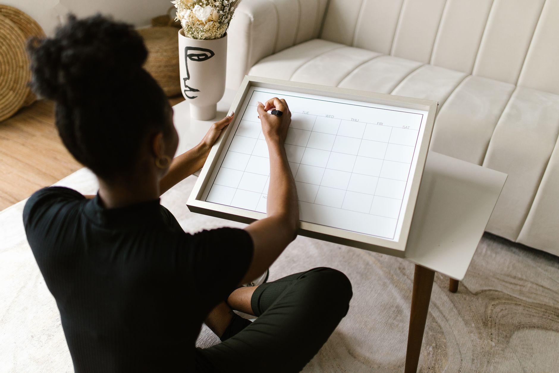 Marketer planning a 2026 digital marketing content calendar on a whiteboard
