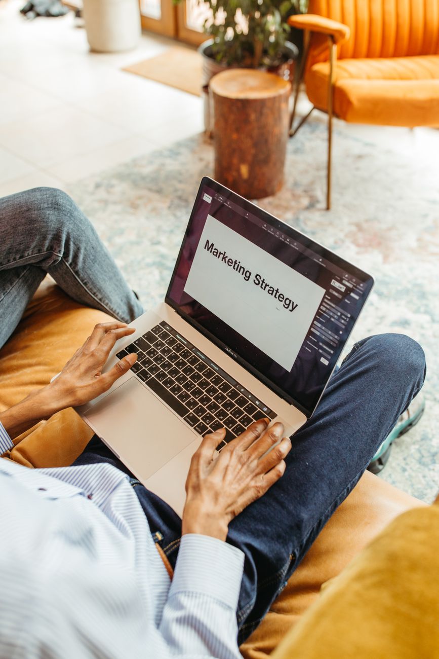 Person working remotely on a laptop with digital marketing dashboards on screen