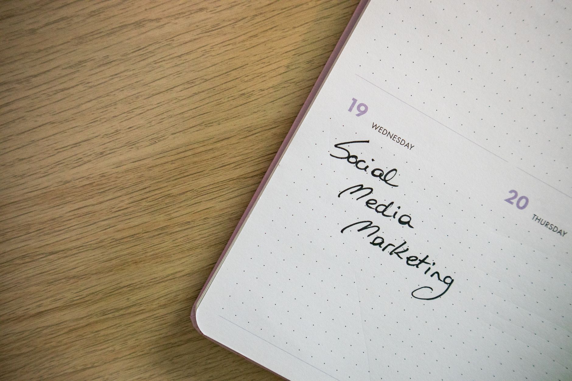 Social media manager scheduling posts and reviewing engagement metrics on a tablet