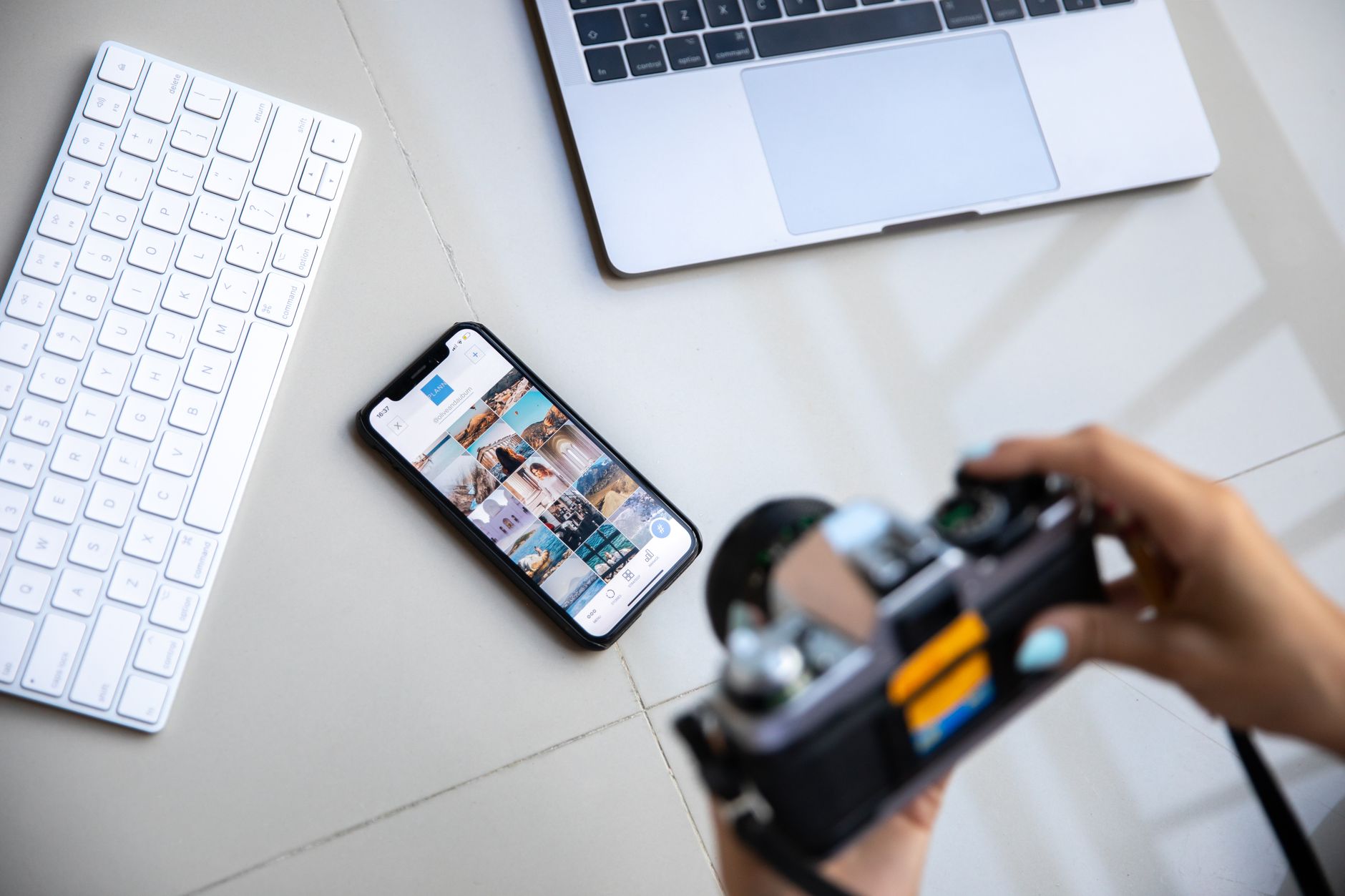 Content creator reviewing short-form video analytics on a laptop and phone