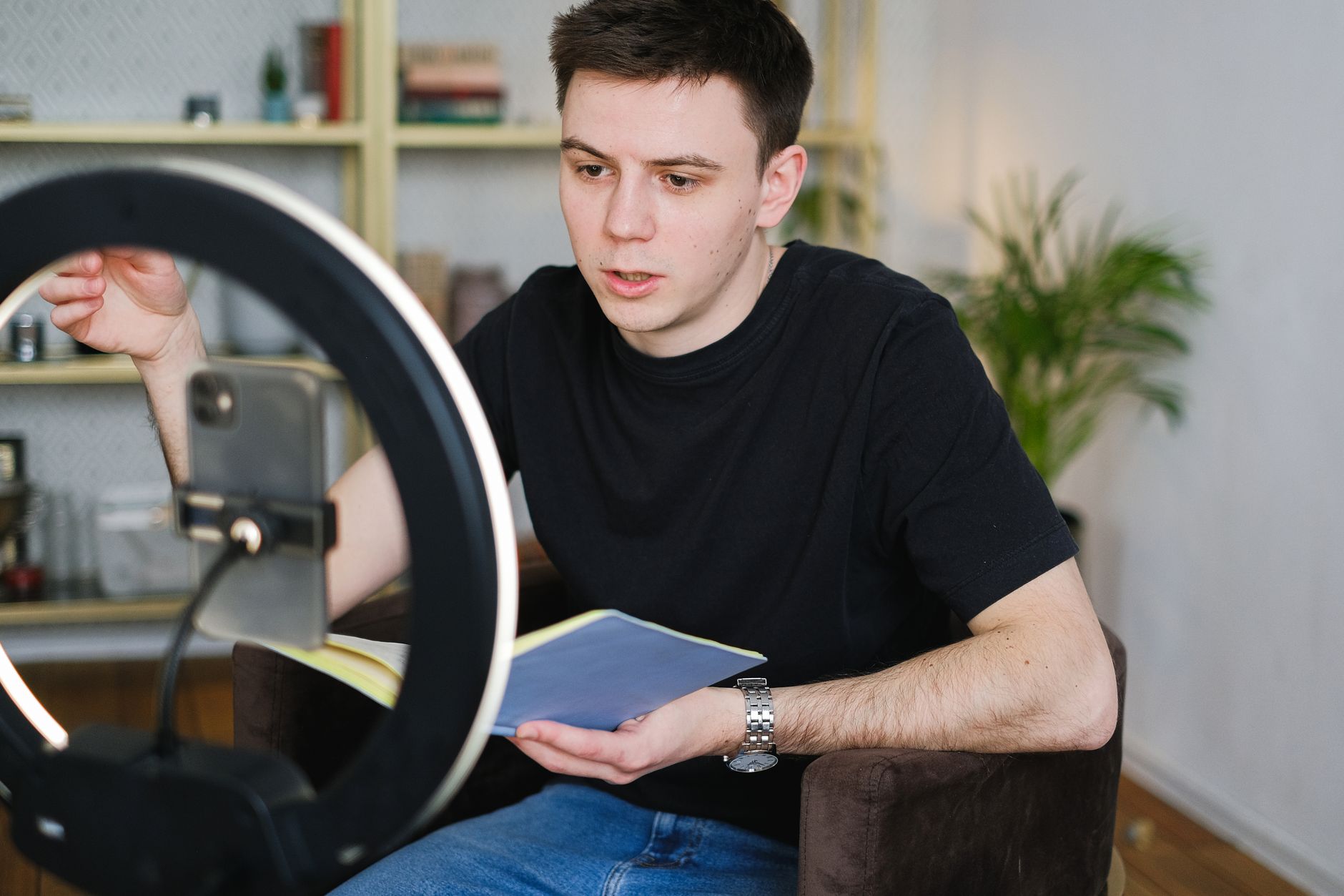 Creator filming short-form video with ring light and smartphone for digital marketing
