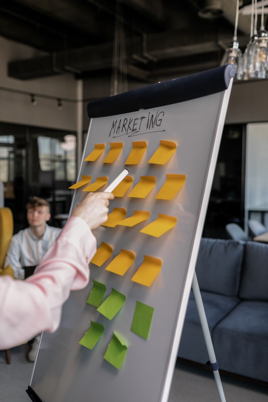 Beginner marketer planning a 30-day digital marketing strategy on a whiteboard