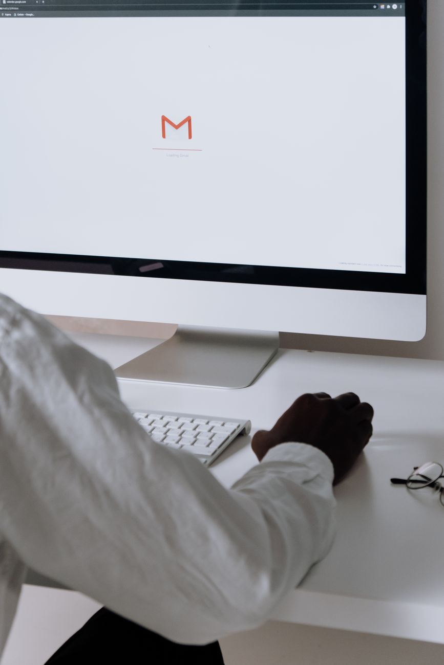 Person composing an email marketing campaign on a desktop computer