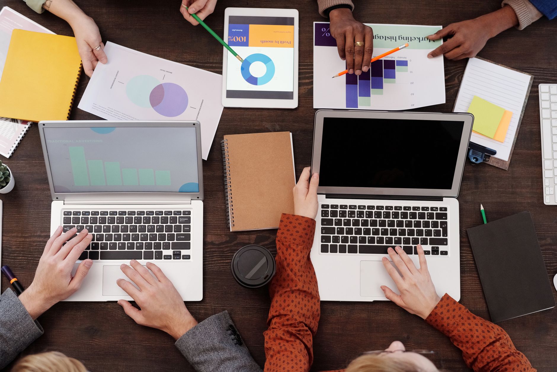 Digital marketing team reviewing salary data on laptops in a modern office