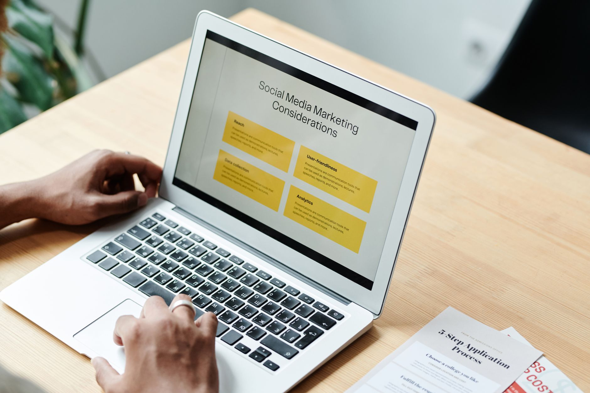 Marketer reviewing social media analytics on a laptop dashboard