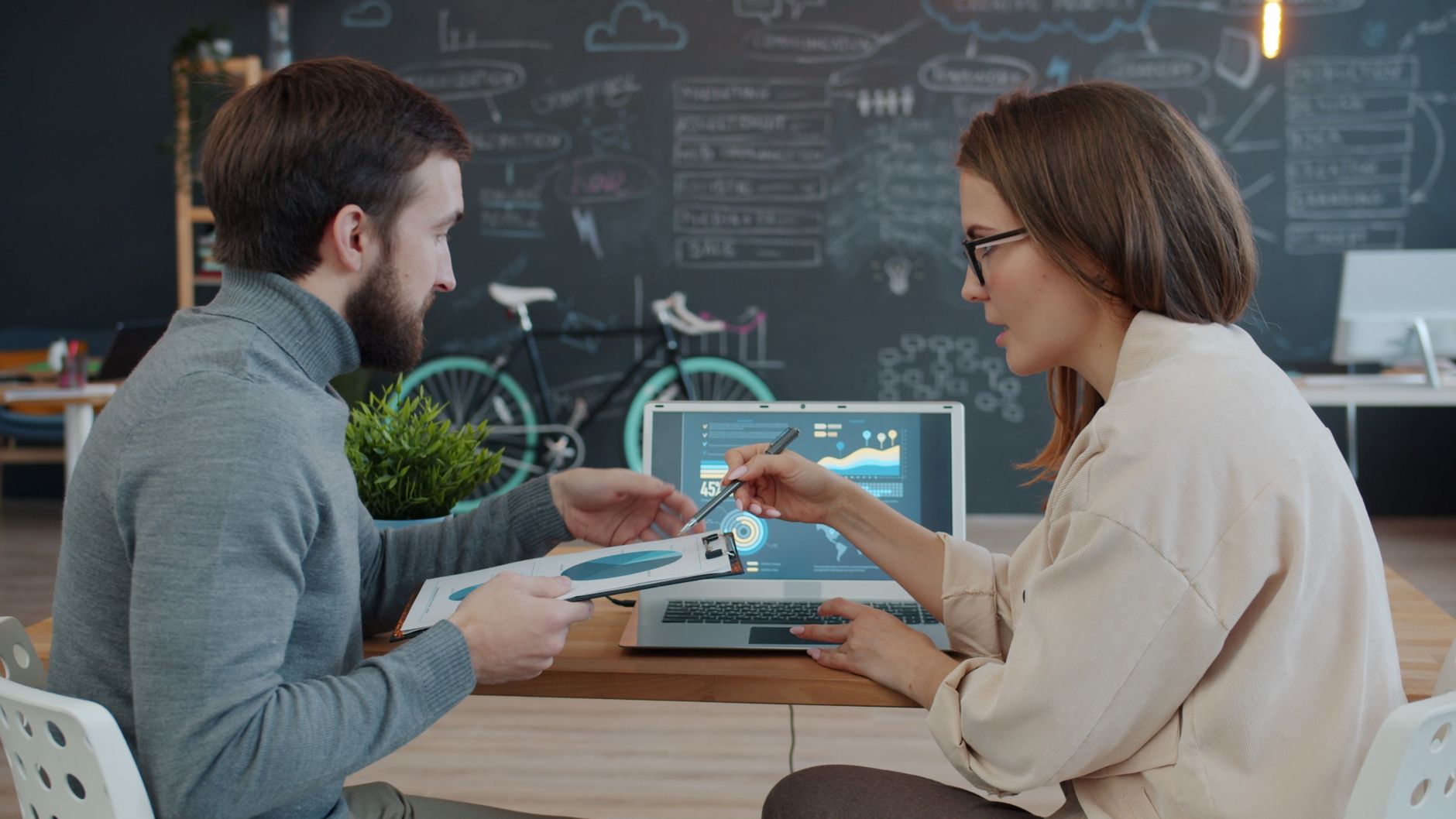 Beginner sitting at a laptop with a 30-day digital marketing plan on screen