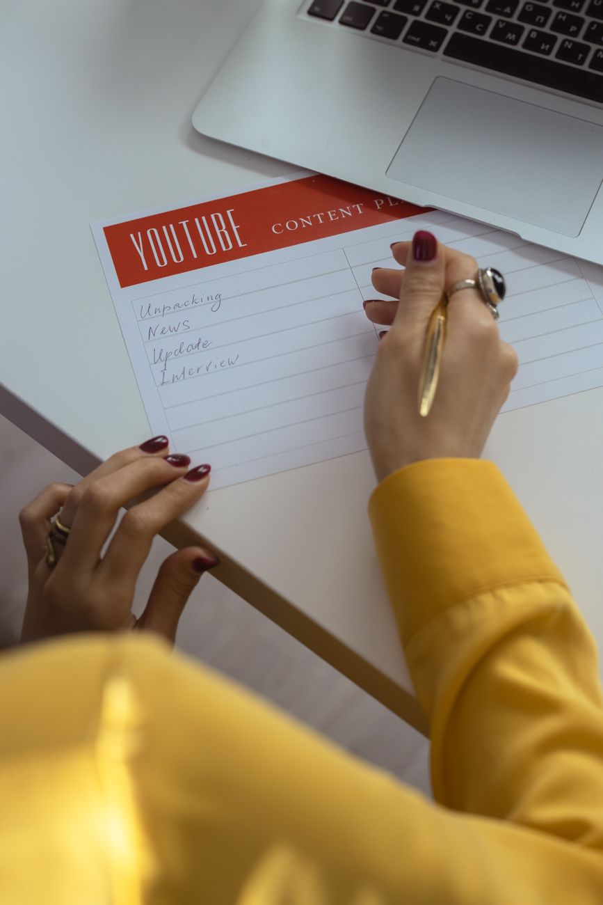 Social media content calendar spread out on a desk with color-coded posts