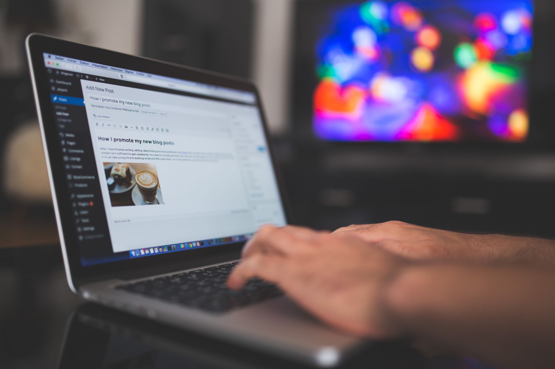 Person writing a digital marketing blog on a laptop