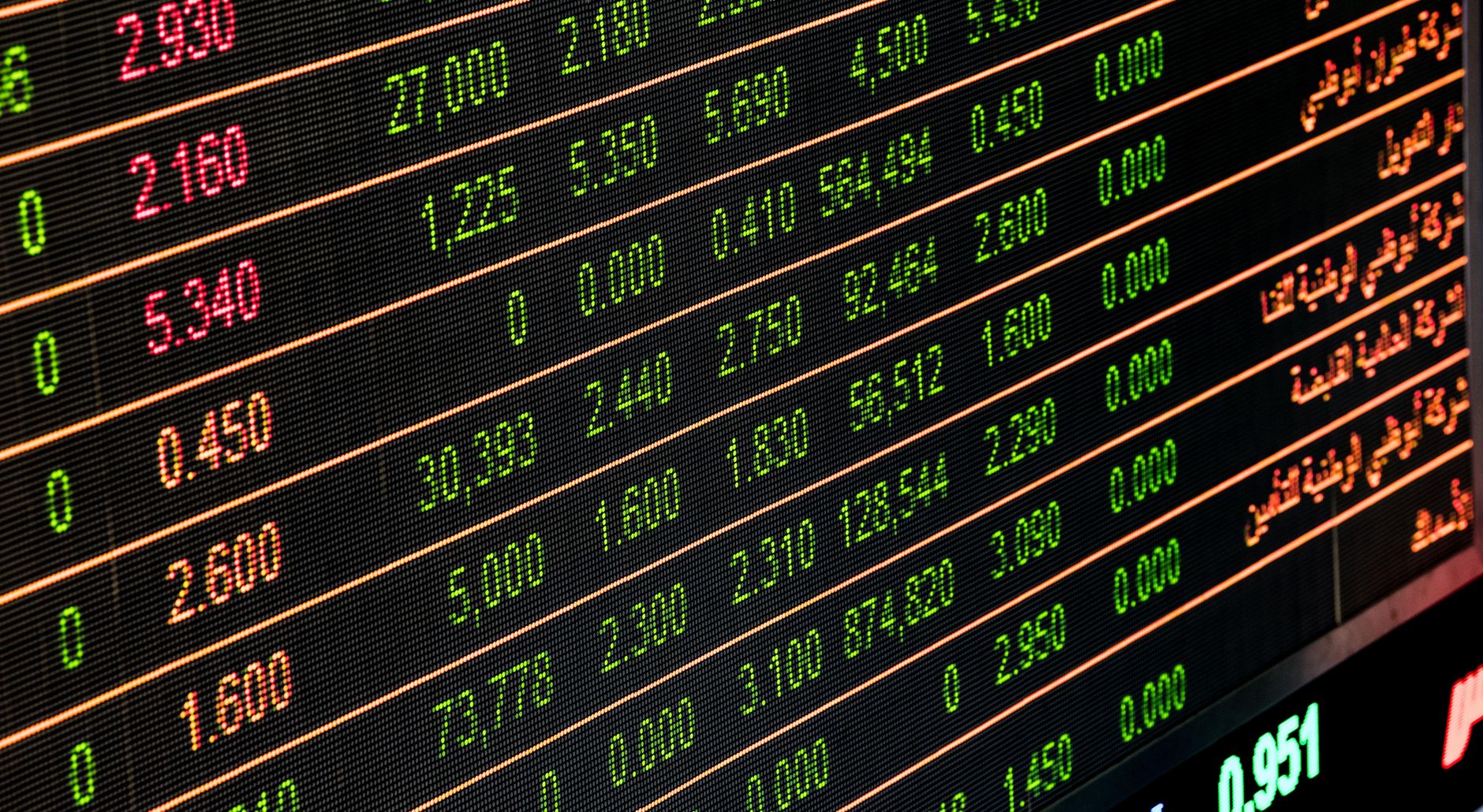 Marketer analyzing performance metrics and KPIs on multiple screens
