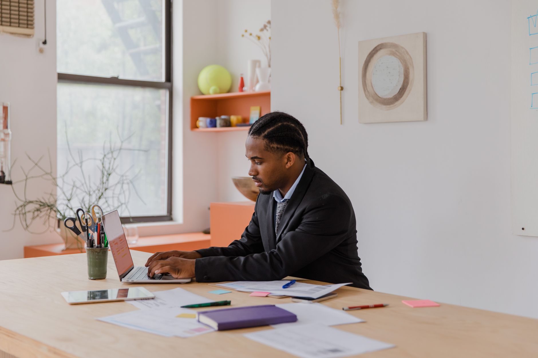 Small business owner reviewing digital marketing strategy on laptop